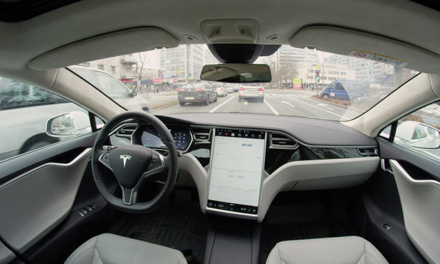 A Tesla Model S self-drives through an urban street. (Photo: Flystock/Shutterstock)