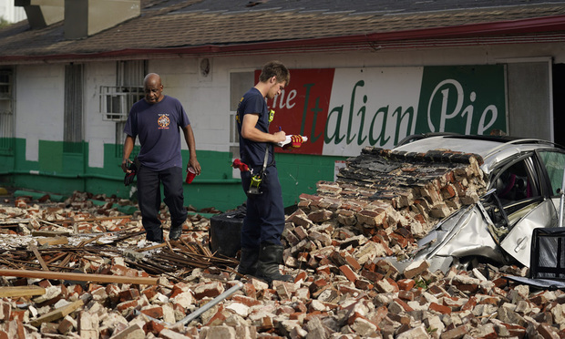 New Orleans Firefighters assess damages as they look through debris after a building collapsed from the effects of Hurricane Ida, Monday, Aug. 30, 2021, in New Orleans, La. (Photo: Eric Gay/AP)