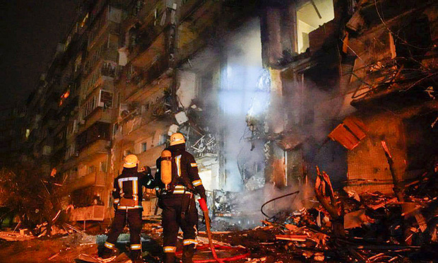 Firefighters inspect the damage at a building following a rocket attack on the city of Kyiv, Ukraine, Friday, Feb. 25, 2022. (Credit: Ukrainian Police Department Press Service via AP)