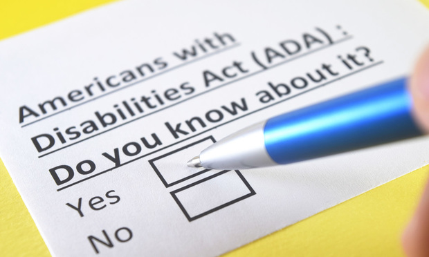 A pen hovers above a slip of paper that reads, “Americans with Disabilities Act (ADA): Do you know about it? With two check boxes beneath reading “yes” and “no.”