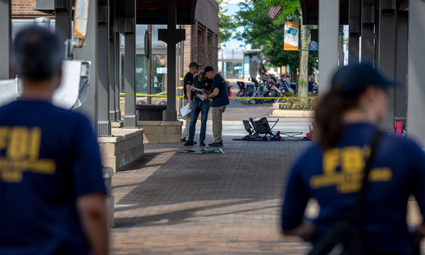 FBI agents work the scene of a shooting at a Fourth of July parade on July 5, 2022 in Highland Park, Ill.(Credit: Jim Vondruska/Getty Images via Bloomberg) 