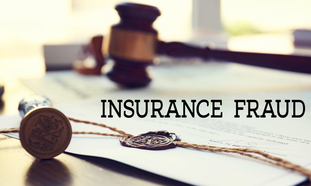 A gavel lies on top of a document with a wax seal. The words "insurance fraud" are superimposed in front of it.