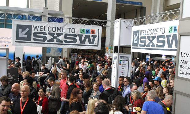 FILE - SXSW Interactive and Film Festival attendees crowd the Austin Convention Center on March 9, 2013, in Austin, Texas. After the pandemic forced the South by Southwest Film Festival to turn virtual the last two years, the Austin, Texas, festival is plotting a largely in-person event this March, with the premieres of the third season of Donald Glover’s “Atlanta,” the latest from Richard Linklater and the Sandra Bullock-Channing Tatum comedy “The Lost City.” (AP Photo/Jack Plunkett, File)