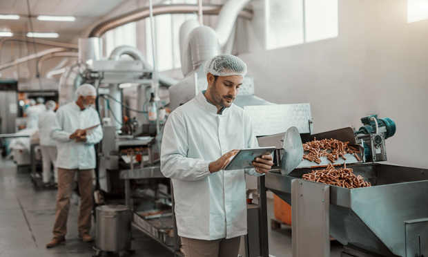 Worker at pretzel production faciltiy.