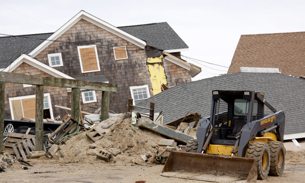 A bulldozer in front of destroyed homes on January 13, 2013 in Lavallette, New Jersey, as clean up continued after Hurricane Sandy struck the shore in October 2012. (Credit: Glynnis Jones/Shutterstock)