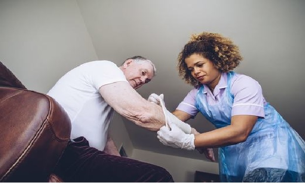 Nurse caring for an elderly injured patient.