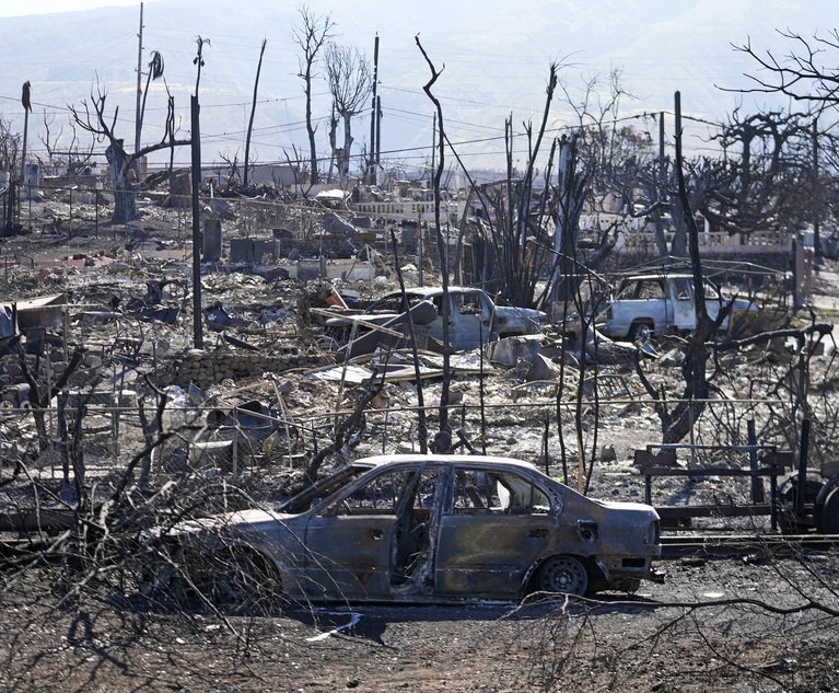 Destroyed homes and cars are shown, Sunday, Aug. 13, 2023, in Lahaina, Hawaii. Hawaii officials urge tourists to avoid traveling to Maui as many hotels prepare to house evacuees and first responders on the island where a wildfire demolished a historic town and killed dozens.