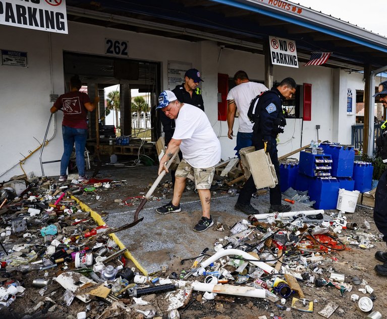 Members of the Miami-Dade Fire Rescue Florida Task Force 1 help residents to remove debris after Hurricane Idalia in Horseshoe Beach, Florida, on Thursday, August 31, 2023. 