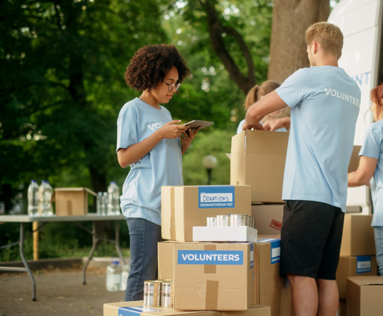 A group of volunteers stacking boxes.