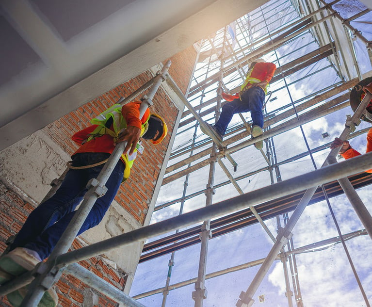 Construction workers climbing on scaffolding