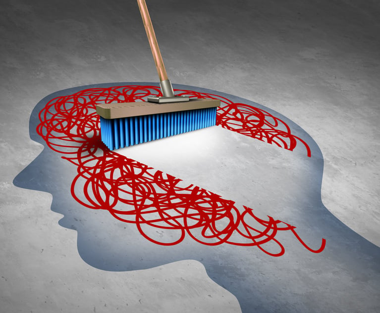 A person is sweeping a broom over an illustration of a head, wiping away red wavy lines inside the head as if to clear the brain.