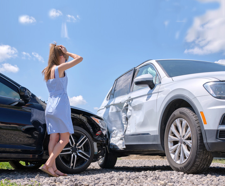 A young woman looks on at a car accident in exasperation