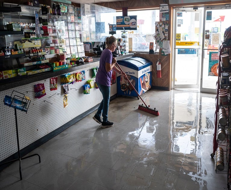 A worker sweeps water from a damaged convenience store after Hurricane Beryl made landfall in Palacios, Texas, on Mon., July 8, 2024. The storm brought heavy rains and life-threatening storm surge after churning across the Caribbean Sea and the Gulf of Mexico. (Photo credit: Eddie Seal/Bloomberg)