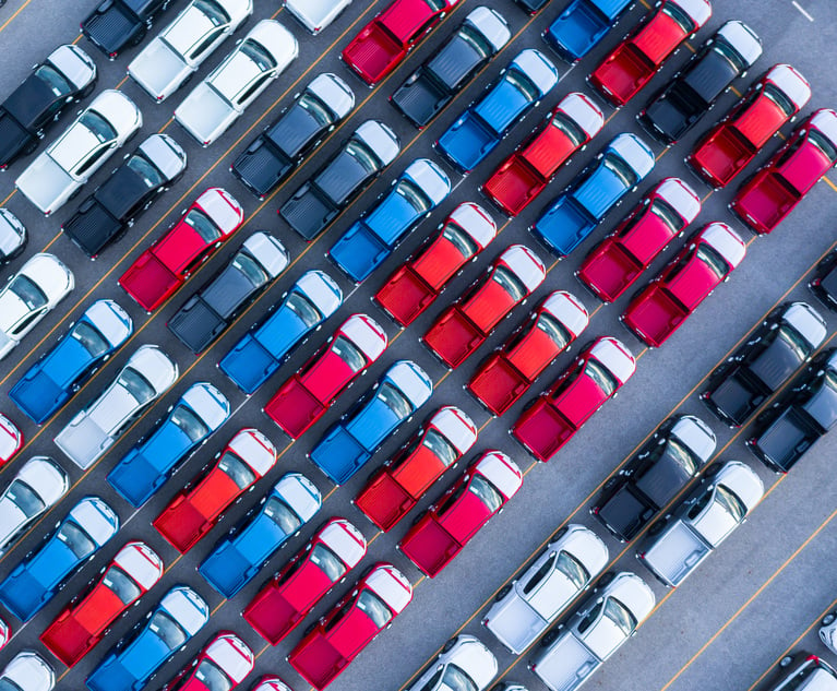 An overhead shot of cars in a parking lot