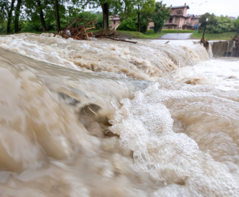 Flood waters rushing down a road