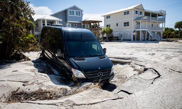 A vehicle stuck in a hole in Boca Grande on Gasparilla Island, Florida, US, on Tuesday, Oct. 15, 2024. The barrier island community of Boca Grande on Florida's west coast sustained significant damage from Hurricane Milton. (Credit: Marco Bello/Bloomberg)