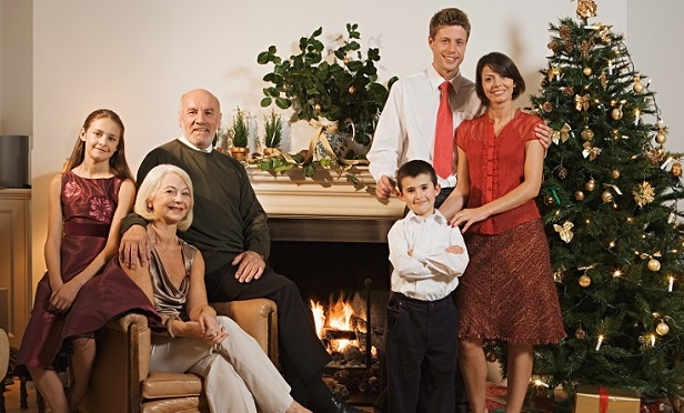 Grandparents, adult children and grandchildren in a Christmas card photo