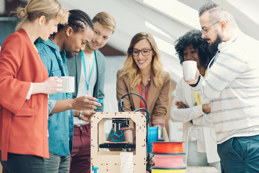 Team standing around an invention